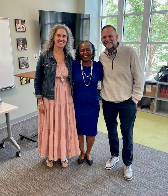 Matt, Buffy, and Lawanda smiling together in a bright community space